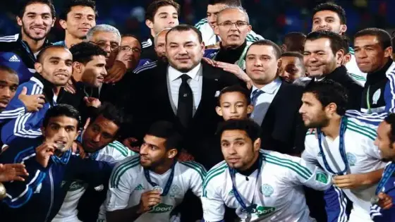 Moroccan King Mohammed VI, center, poses for a group photo with the team of Raja Casablanca after Bayern won the final of the soccer Club World Cup between FC Bayern Munich and Raja Casablanca in Marrakech, Morocco, Saturday, Dec. 21, 2013. (AP Photo/Matthias Schrader)