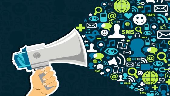 Hand holding a megaphone throwing social media icons on blue background. Vector file available.