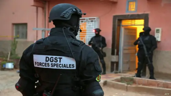 Members of Moroccos's Central Bureau of Judicial Investigation (BCIJ), which oversees counter-terrorism operations, gather outside a house in the southern city of Errachidia on September 14, 2021. - Moroccan authorities have dismantled a cell of Islamic State group-affiliated militants and arrested three suspects accused of plotting an assassination, security services said today. Security forces searched the suspects' homes and a shop, where they found military clothing, jihadist literature and information, it said. (Photo by AFP)